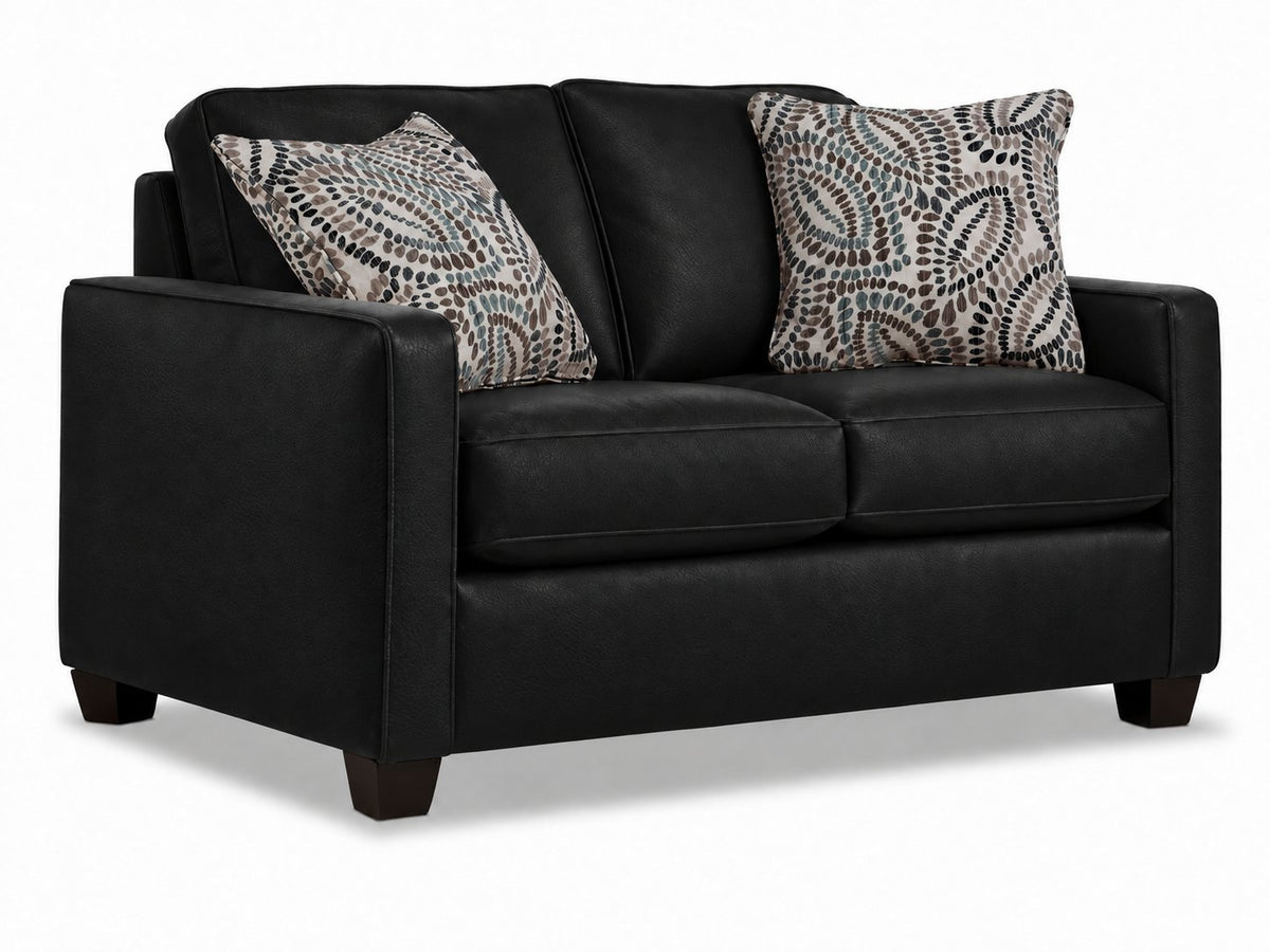 City Leather Loveseat - Black in a three-quarter view with two cushioned seats, slim track arms, dark wood legs and two patterned accent pillows
