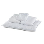Twin XL 7-Piece White Dream Bedding Bundle with white pillows, folded bedding and sleep mask arranged together