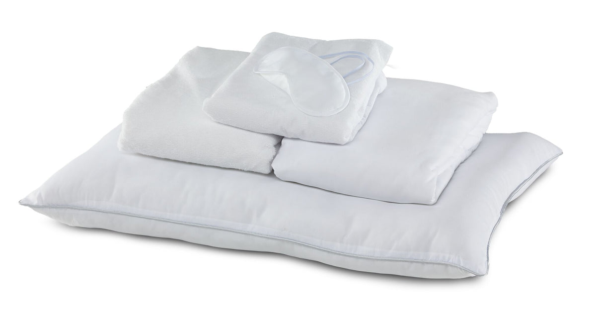 Twin XL 7-Piece White Dream Bedding Bundle with white pillows, folded bedding and sleep mask arranged together