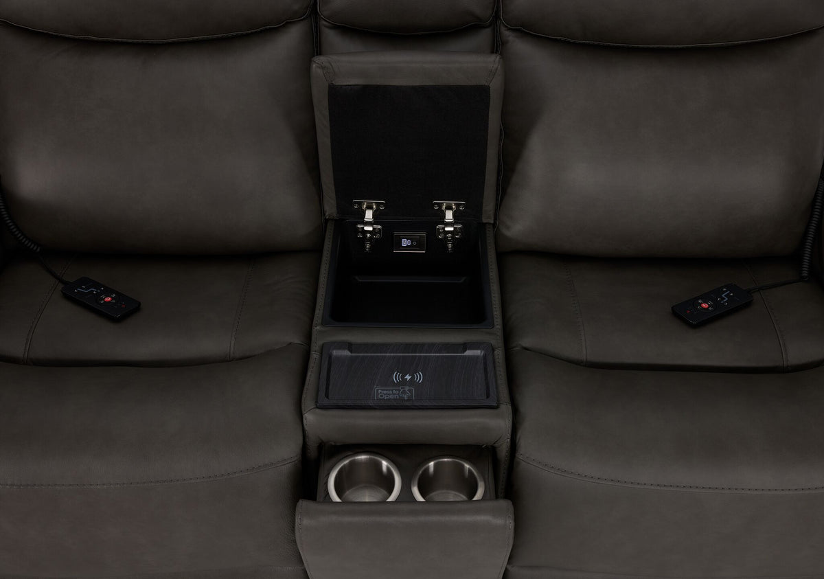 Jackson loveseat centre console close-up showing open storage, wireless charging pad, dual cupholders and remotes