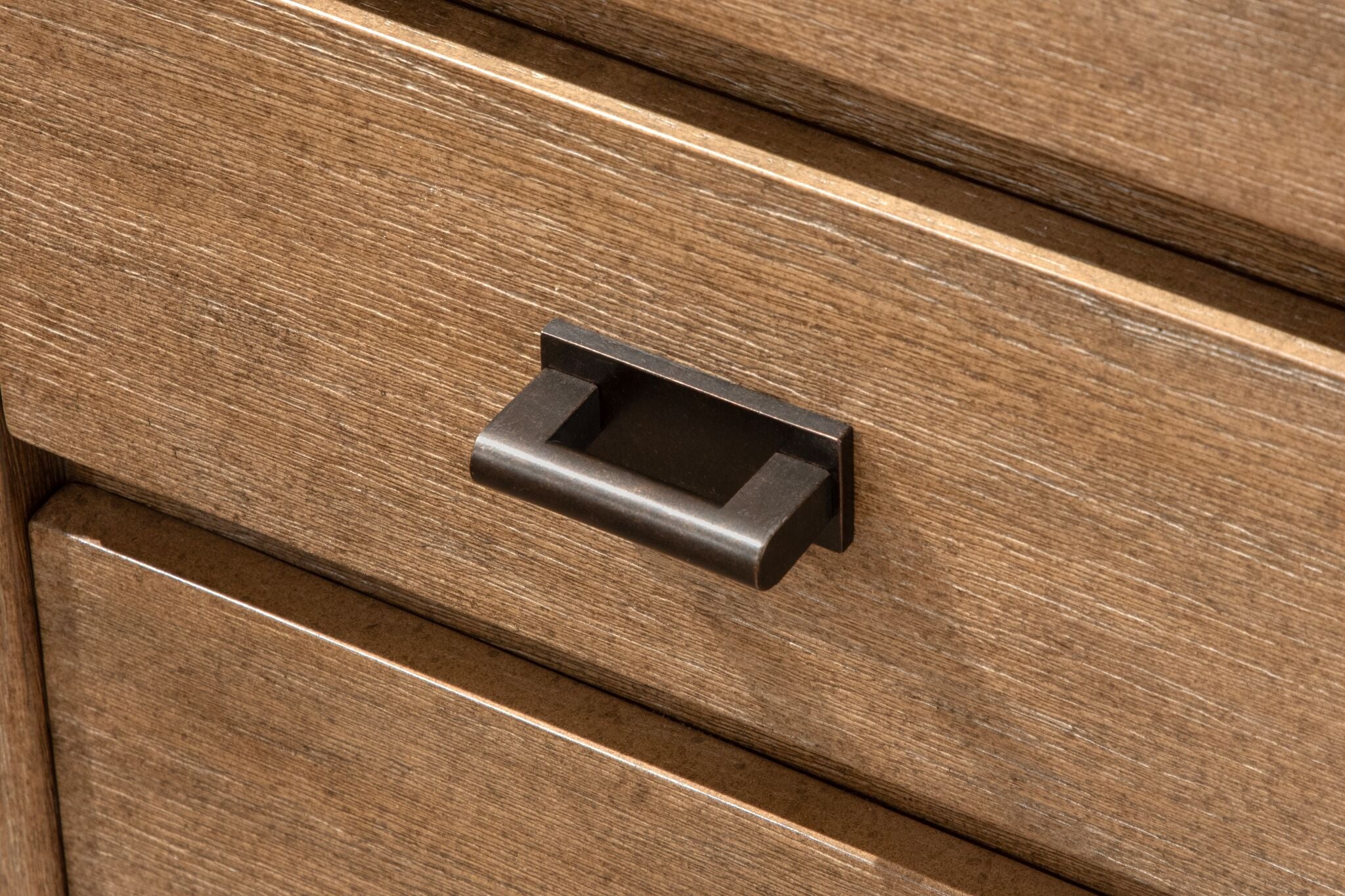 Plum Creek filing cabinet close-up showing drawer front, wood grain and oil-rubbed bronze hardware