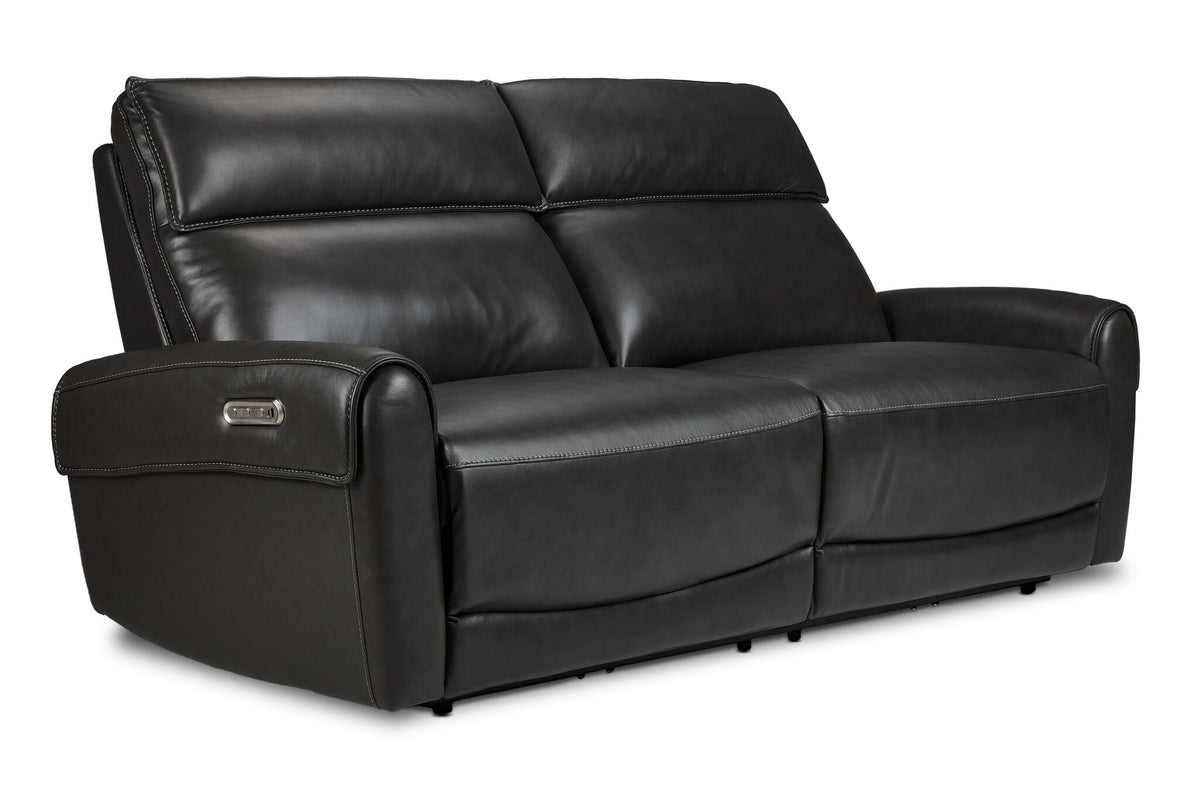 Theo Leather Dual Power Reclining Sofa - Charcoal shown at an angle with plush back cushions, padded headrests and curved arms