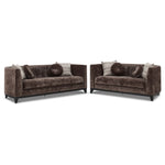Tresor dark brown sofa and loveseat set with curved backs, button-tufted detail and accent pillows