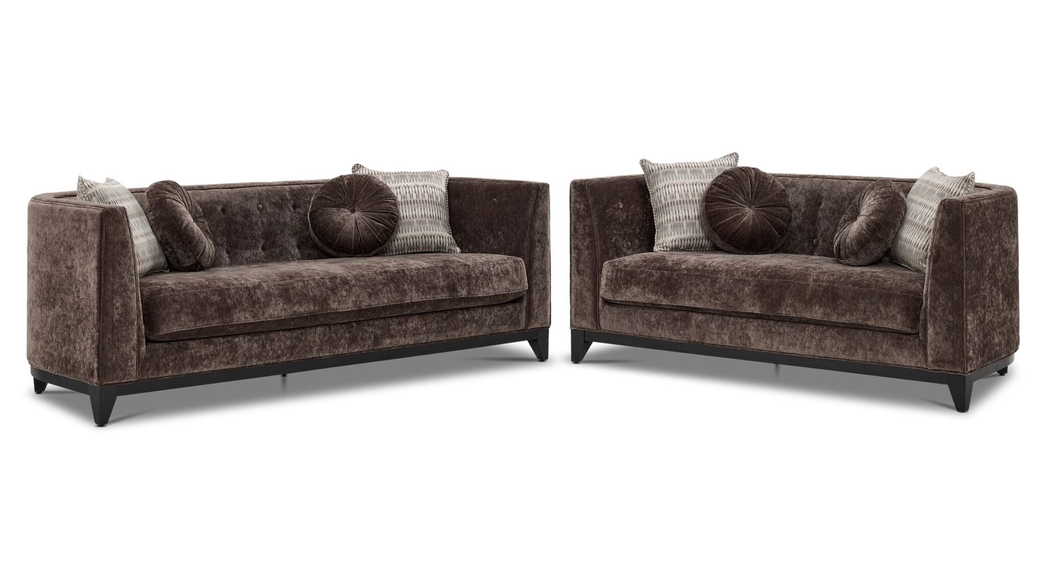 Tresor dark brown sofa and loveseat set with curved backs, button-tufted detail and accent pillows