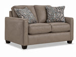 City Leather Loveseat - Stone in a three-quarter view with two cushioned seats, patterned accent pillows and dark wood legs