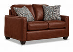 City Leather Sofa - Brown in a three-quarter view with three seat cushions, patterned accent pillows and dark wood legs