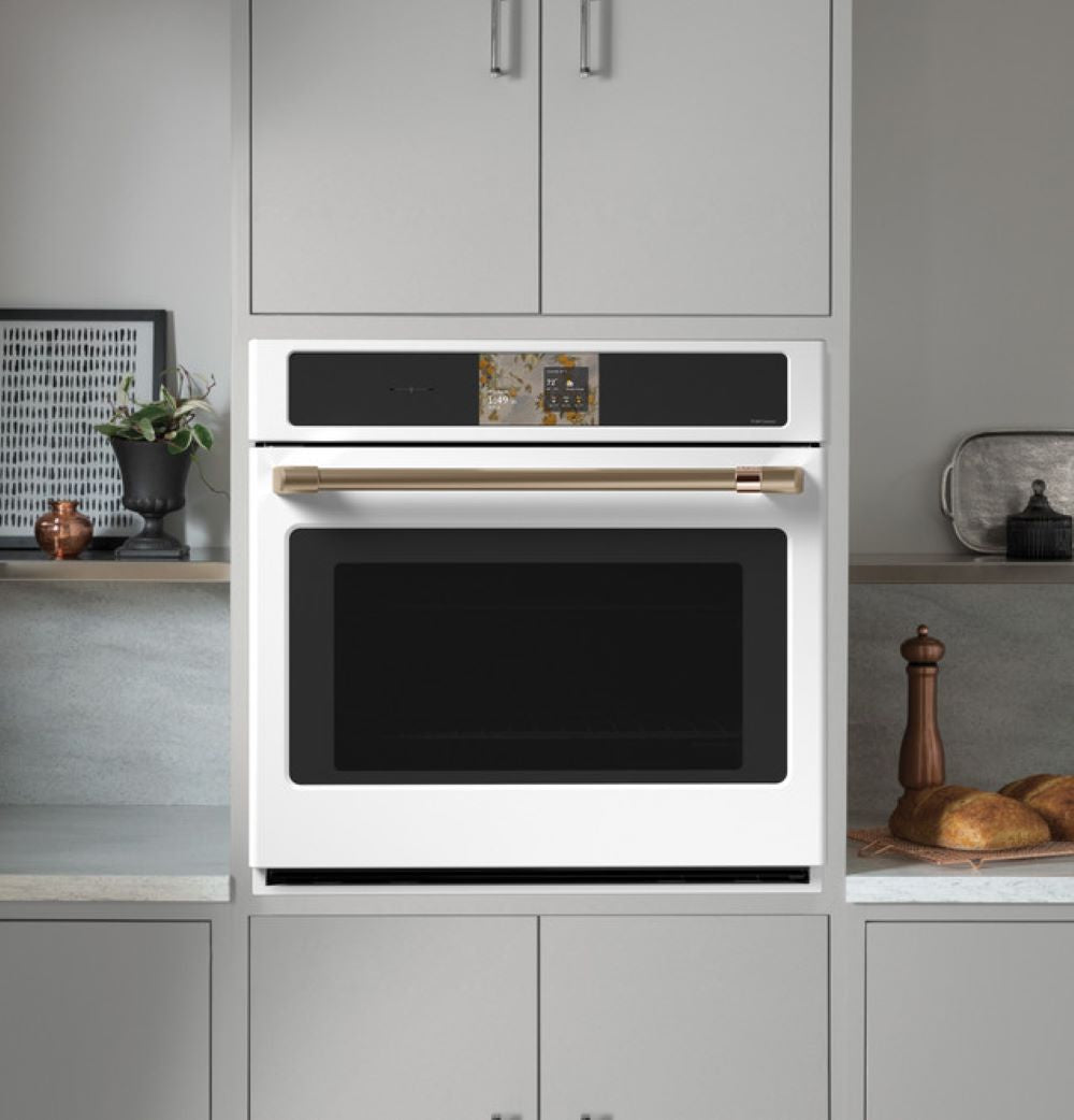 CAFÉ™ Professional Series 30" Matte White Smart Wall Oven open showing convection fan and oven racks