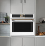 CAFÉ™ Professional Series 30" Matte White Smart Wall Oven open showing convection fan and oven racks