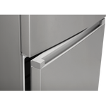Detail of the recessed handle between the stainless steel freezer and refrigerator doors