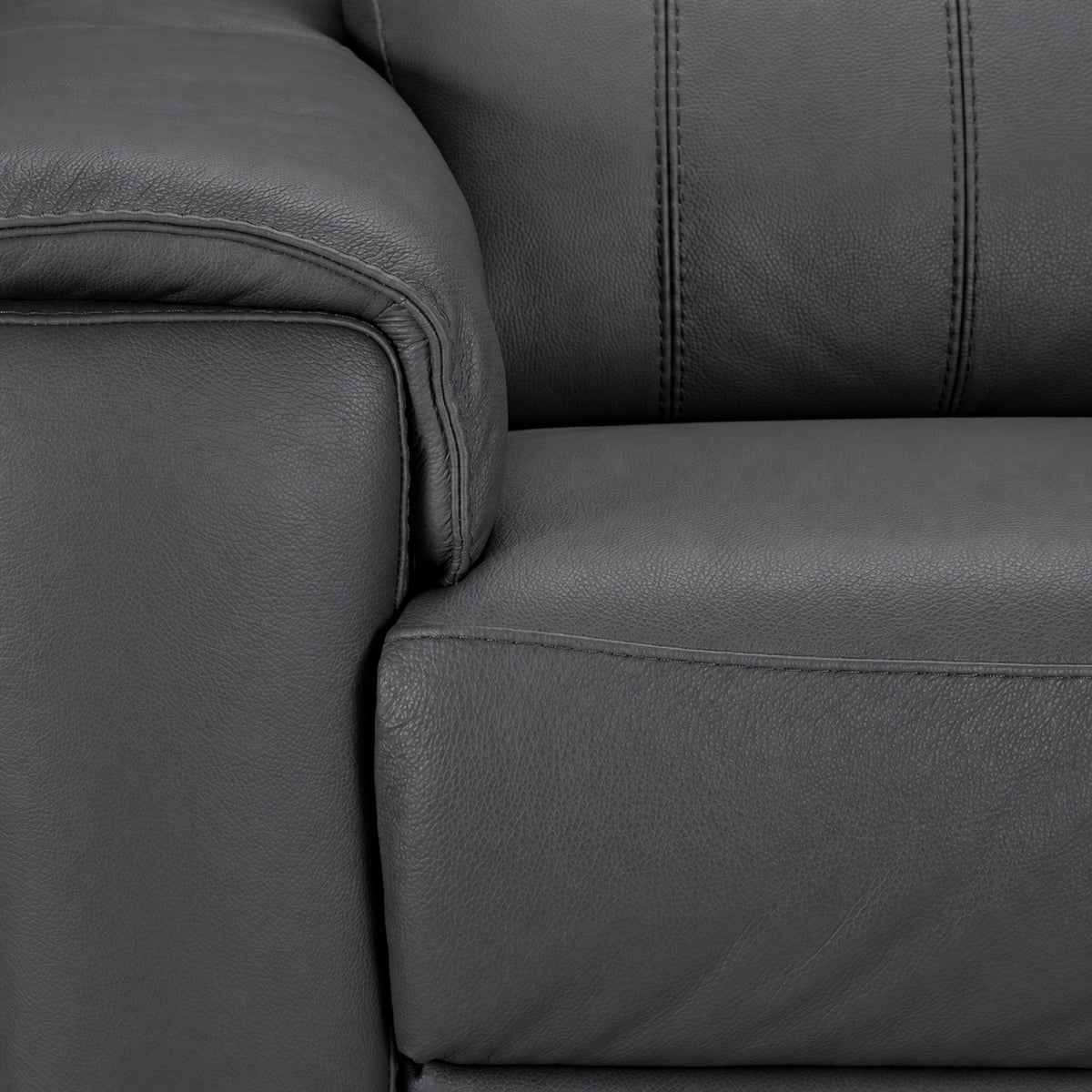 Close-up of the leather chair arm, seat cushion and stitched backrest detail
