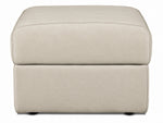 Front view of the cream leather ottoman with rounded padded top and low-profile feet