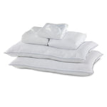 Full 10-Piece White Dream Bedding Bundle with white pillows, folded bedding and sleep mask arranged together
