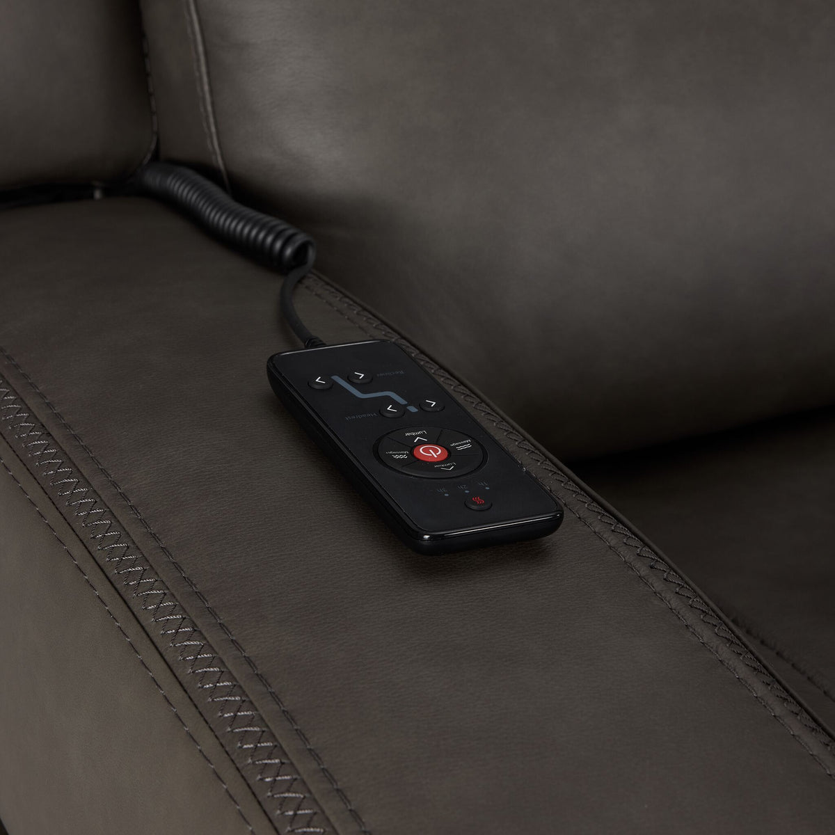 Jackson anthracite leather sofa close-up showing wired remote for power recline, heat and massage controls
