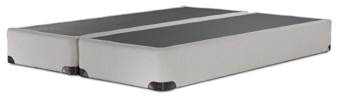 Kingsdown White Boucle king split boxspring with beige polyester upholstery and a black support surface, angled view