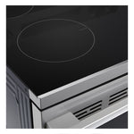 Close-up of LG black glass induction cooktop showing outlined cooking zone and stainless steel front edge