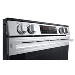 Close-up of LG electric slide-in range front control panel with four knobs and ThinQ digital display