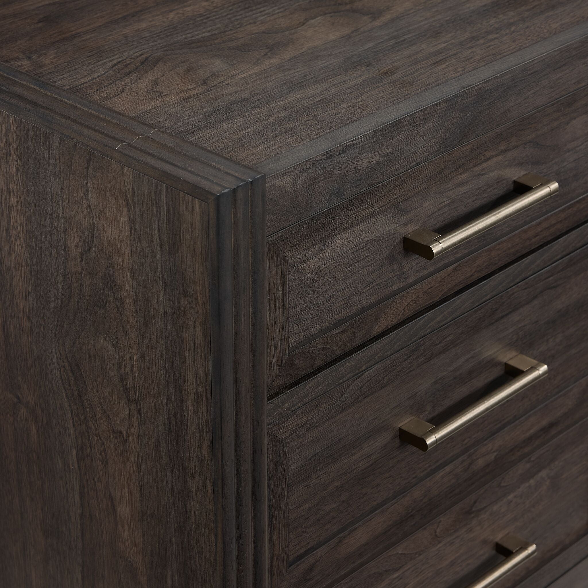 Modern Edge filing cabinet close-up showing dark grey finish, bar pull hardware and picture frame moulding