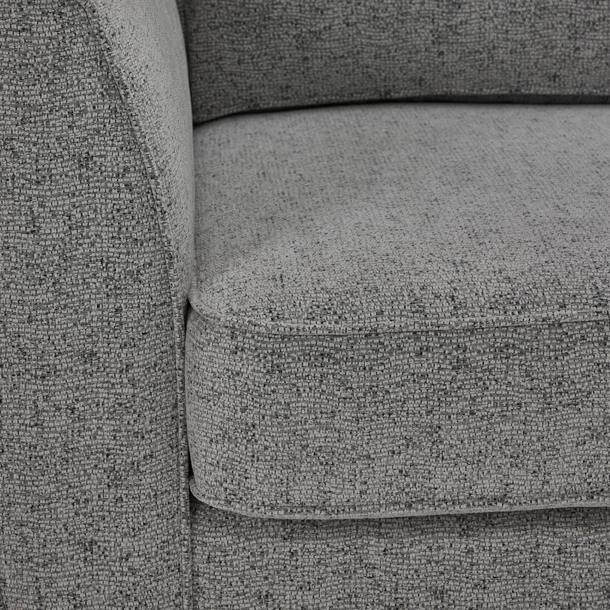 Moncton sofa close-up showing light grey polyester upholstery, cushion edge and seam detail