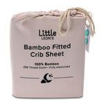 Little Leon’s Bamboo Fitted Crib Sheet in Morganite pink drawstring packaging with 100% bamboo and 250 thread count details