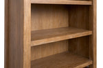 Plum Creek bookcase close-up showing wood grain shelf edge and Sierra Brown finish