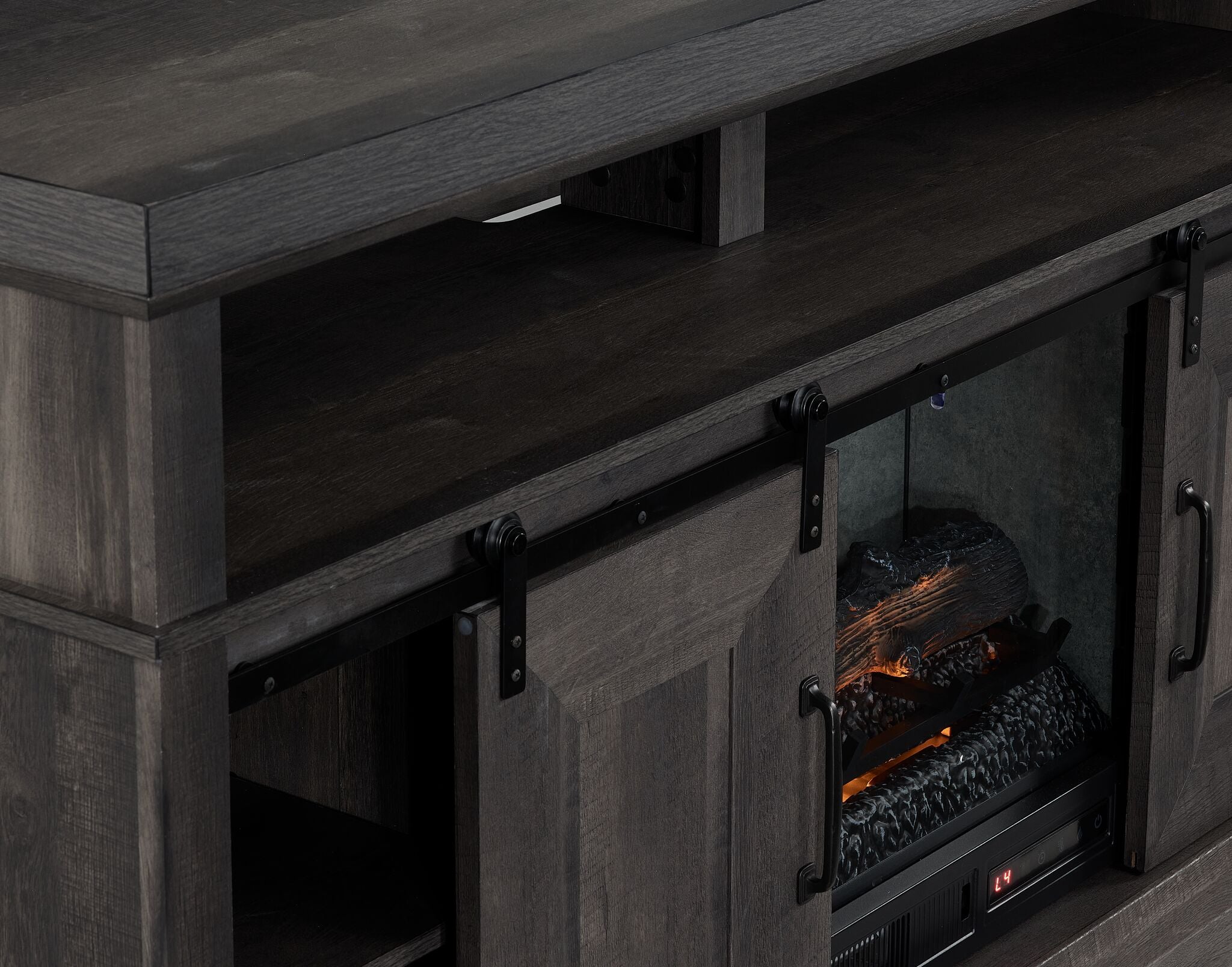 Close-up of Preston charcoal Fireplace TV Stand showing black sliding barn door hardware, open shelf and fireplace insert