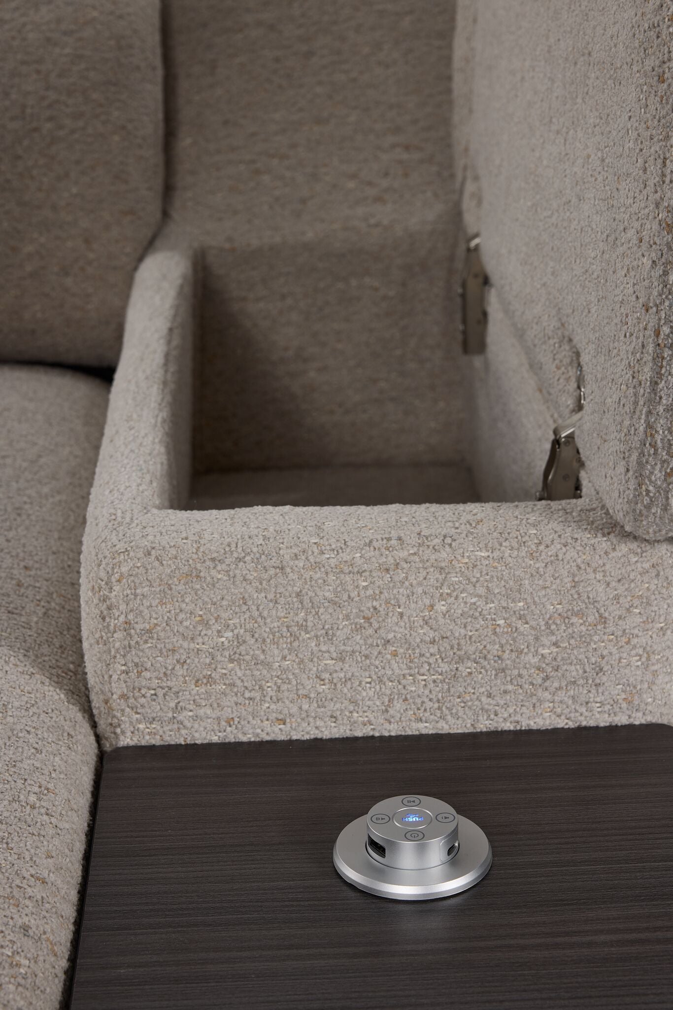 Close-up of Slayden left-facing taupe sectional showing open arm storage, side table and USB control panel