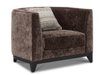 Tresor dark brown chair with curved back, button-tufted detail, accent pillow and angled front view