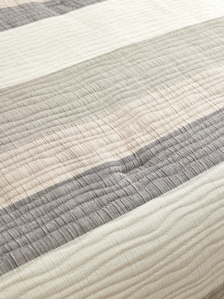 Close-up of The Great Indoors 5-Piece King Comforter Set showing quilted cream, beige and grey striped fabric