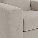 Valetta ivory upholstery close-up showing textured fabric and decorative cross stitching on the wide track arm
